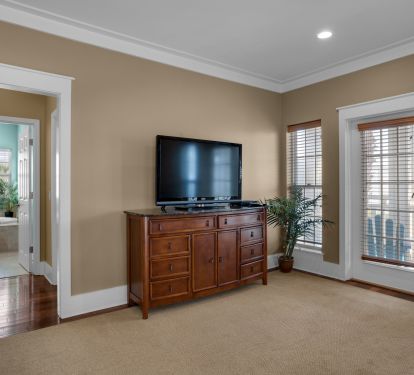 Master bedroom toward the en-suite bathroom and the master balcony.