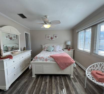 This bedroom offers a comfortable queen bed, tasteful decor and flat screen tv.
