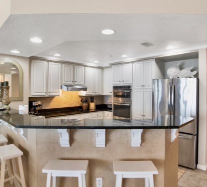 Colonnades kitchen - with bar seating for 4, granite counters and stainless