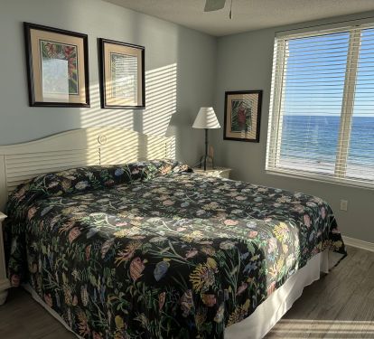 Master bedroom with updated flooring and bathroom with large walk-in shower.