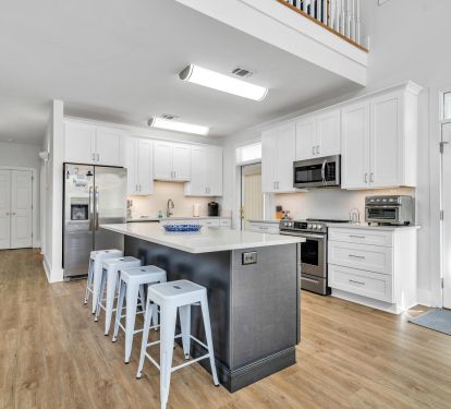 Remodeled kitchen with updated appliances, island seating for four