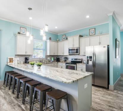 Large, spacious kitchen has luxury granite countertops, plenty of bar seating
