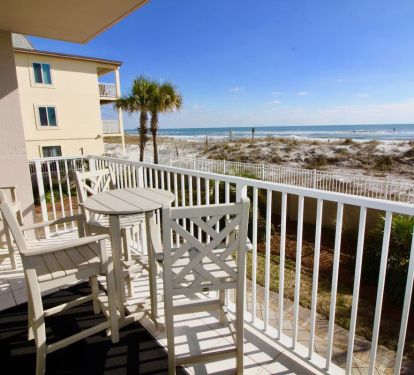 Balcony view. Four pub height chairs and a table