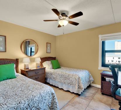 Twin bedroom has workstation and printer.
