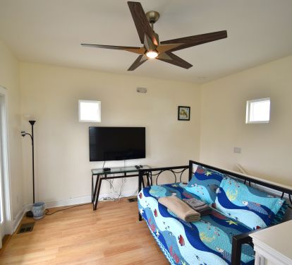 Loft bedroom with twin daybed popup trundle, 52 inch Roku TV, &amp; private balcony