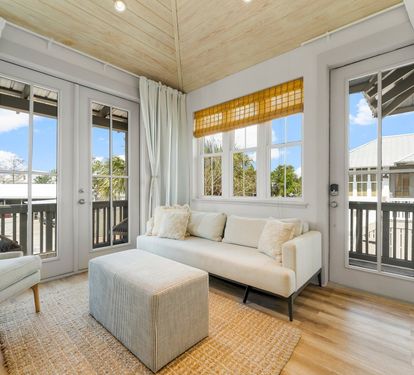 Kick back on the sofa as light pours through the French doors