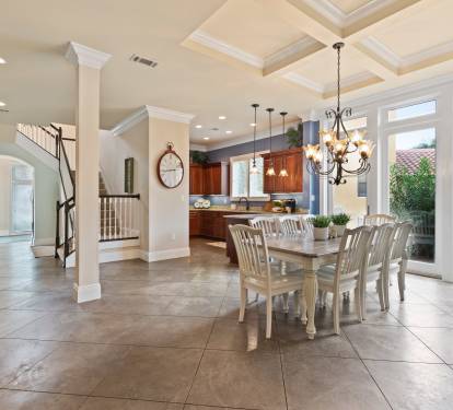 Large dining table next to kitchen.  Two stool also at kitchen counter
