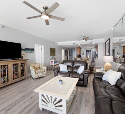 Living Room with Private Balcony Access and 60 Inch Smart TV