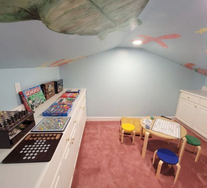 Under the sea adventure awaits! ðŸŒŠðŸ  Dive into fun with this playful kids' playroom, featuring a sea life mural on the ceiling, board games, a cozy kids' table &amp; stools. Perfect for endless hours of family fun.