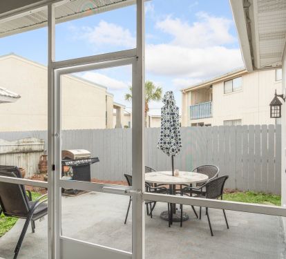 Outdoor patio area, fenced yard and gas grill