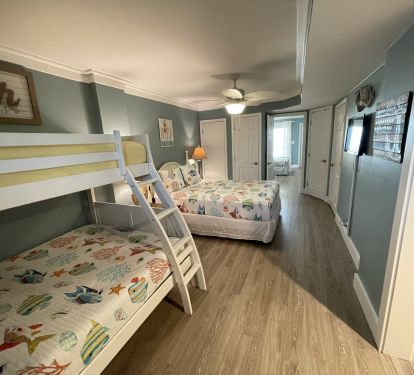 Family lower level front bedroom: queen bed,new twin over full bunk. Entryway on right
