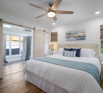 BR 2 has a king bed, large screen tv, and a sunroom overlooking patio/pool area.