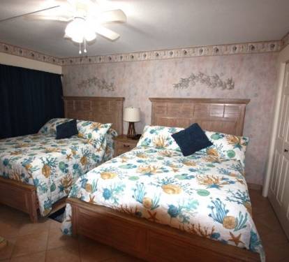 Another view of beds and shows the closet.