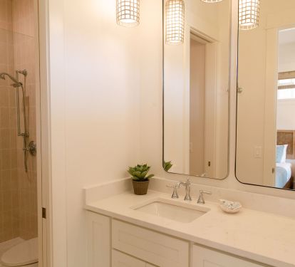 On-suite bath for family bedroom features private water closet and shower.