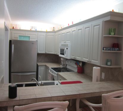 Breakfast bar and view of fully equipped kitchen.