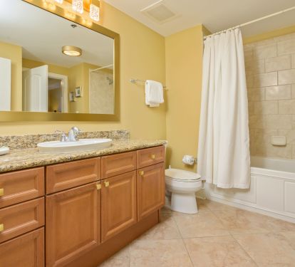 Brushed gold accents create a fresh look in the hall bathroom