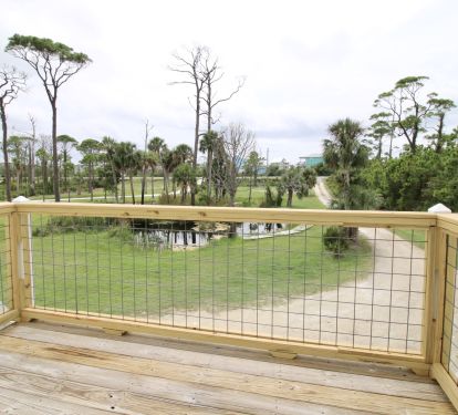 Deck on front of home overlooking front yard pond and driveway leading to CSB Rd