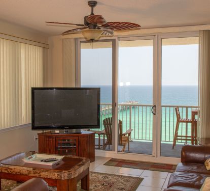 Living room with fan and wrap around balcony