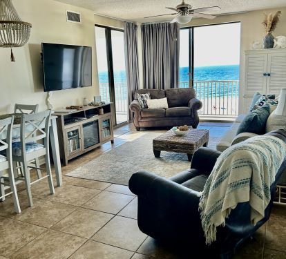 Living and dining area with two sets of sliding glass doors leading to balcony