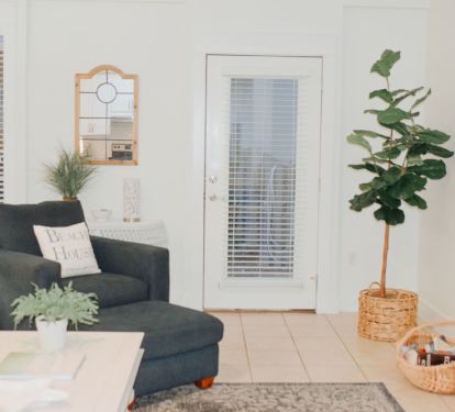 Side door opens to patio with propane grill