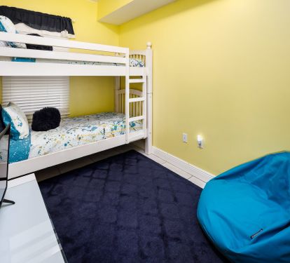 Bunk beds, TV, and comfy seating in the kids' room!