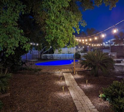 The LED and pool lights bring this backyard to life.
