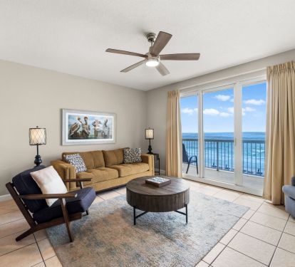 Beachfront living room with ocean-view balcony and coastal furnishings