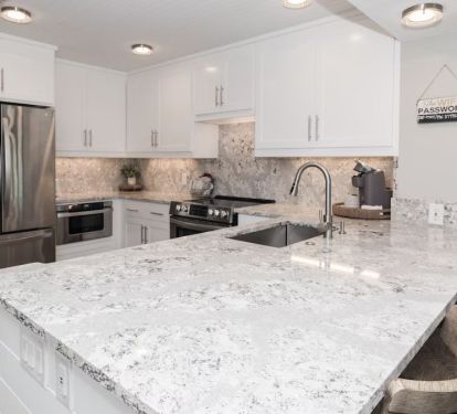 Updated and fully-stocked kitchen with quartz counters &amp; stainless appliances.