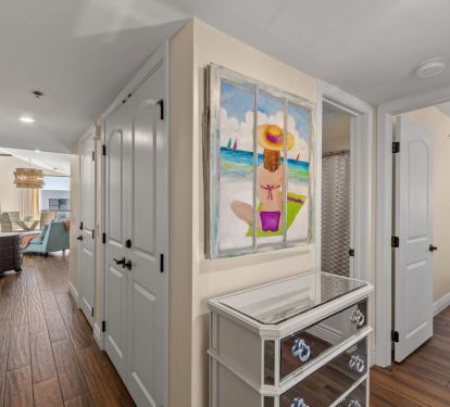 Entry way leads to two open living areas with kitchen bar in center.