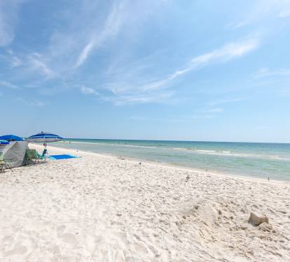 Clean white sand beach with chairs and umbrellas available to rent