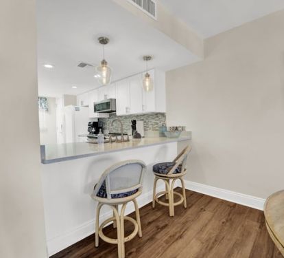 Counter seating next to dining table. 