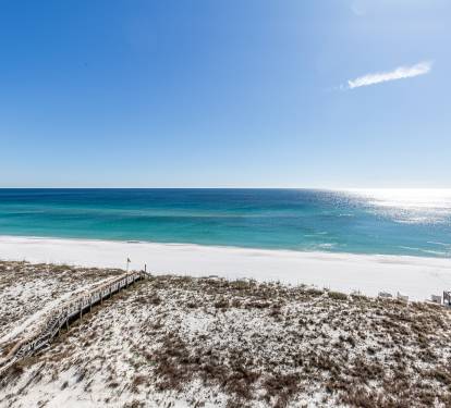 Beach with white sand and emerald waters.