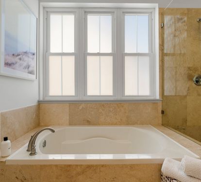 Soak away the day in a deep tub beneath sunlit windows in the top-floor Primary King Suite 