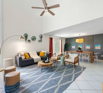 Cozy up at Seabreeze Villa ðŸ”¥ This inviting living room features a warm fireplace and coastal-inspired decor&mdash;perfect for relaxing after a day at the beach. Your seaside escape is just a booking away! ðŸŒ´âœ¨