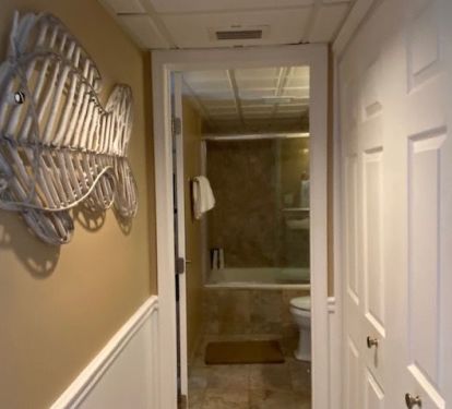 Bath hallway has full size washer and dryer in closet.