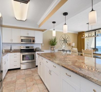 Kitchen with raised ceiling and granite countertops