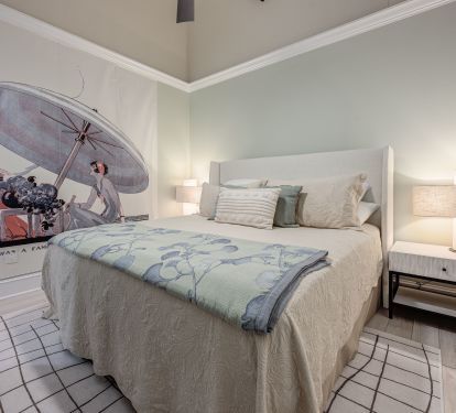 Peaceful green bedroom with an attached study and curated artwork&mdash;perfect for relaxing or catching up on work.
