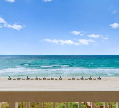 Panoramic Gulf view with turquoise waters, sandy beach, and beach chair setup