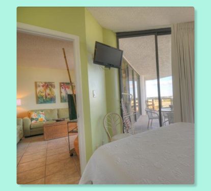 View from the 2nd bedroom into the living room and onto the balcony.