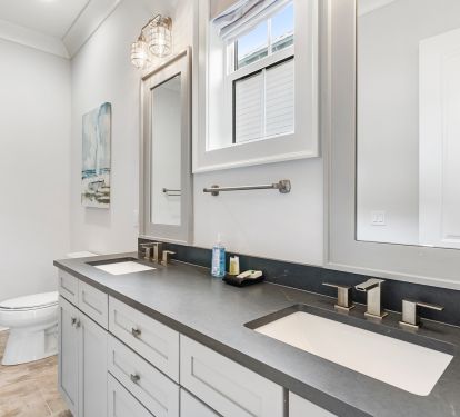 Bathrooms have modern, high end finishes custom tile work