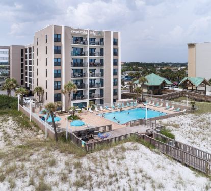 View of the building from the beach, the pool is between the building and beach.