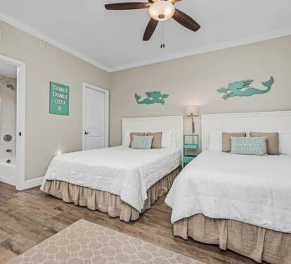The second bedroom comfortably fits two queen beds and has private entry into the main bathroom