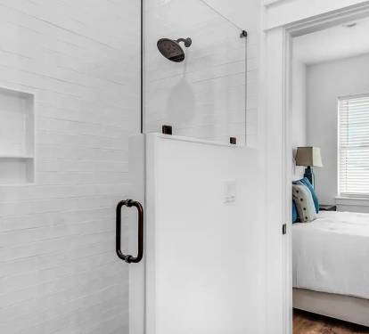 Latitude-21 1st floor. Bed 2 bath, photo 2. Quartz vanity with tiled, frameless glass walk in shower.