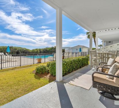 Covered porch steps away from pool 