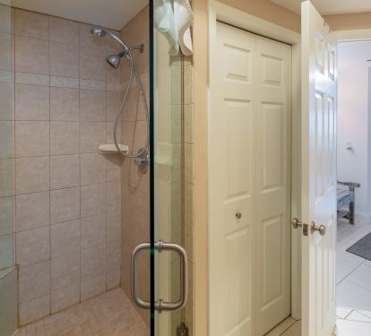 Shower and laundry closet in primary suite