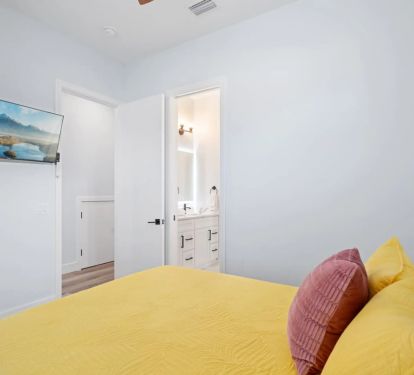 Second Queen bedroom downstairs with jack and jill bathroom and large smart TV