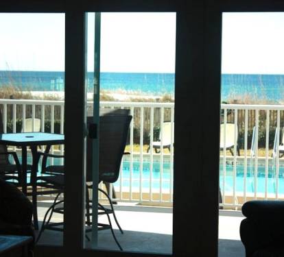 View from inside the condo to pool and beach