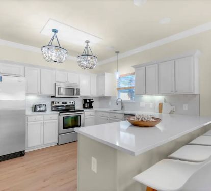 Shipwatch-8 New quartz counters with breakfast bar. Stainless appliances and oh-too-cool oyster shell (yep, oyster shell) lighting.