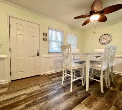 The dining area provides seating for 6 and 2 additional barstools at the bar.