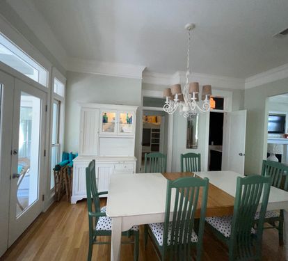 Open concept main living area with views of the front and back porches